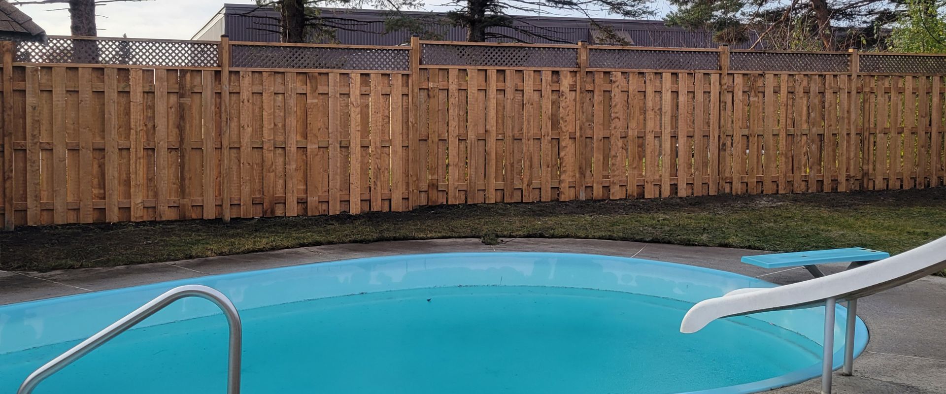 Pressure Treated Fence With Lattice Surrounding a Pool in Ottawa